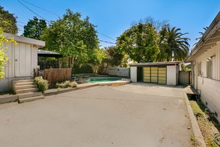 The property also includes a small shed and a two-car garage with direct access to an alleyway. 