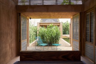 The end of each bedroom opens up to a private brick patio connecting the two spaces. Doors along the side also open up to full expose the bedroom spaces to the pool. 