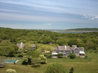 First built in 1981, the main house sits in the middle of the farm, overlooking views of the Atlantic Ocean and Squibnocket Pond. Clad in cedar-shake siding, the home follows the traditional Cape Cod style.
