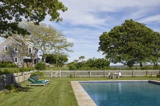 A large pool is surrounded by a grassy area for relaxing and entertaining. The Kennedys have long enjoyed this home as a summer retreat for their large family and close friends.