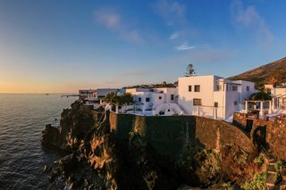 The home is spread out along the eastern edge of Stromboli, a volcanic island in the Tyrrhenian Sea. The island can be found in the Aeolian archipelago just<span style="font-family: Theinhardt, -apple-system, BlinkMacSystemFont, "Segoe UI", Roboto, Oxygen-Sans, Ubuntu, Cantarell, "Helvetica Neue", sans-serif;"> north of Sicily.</span>