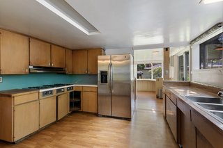 A large kitchen is located along the rear of first floor, off the dining room. Windows run above the sink and lead into a bright breakfast nook in the rear. 