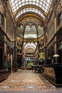 The intricate detailing of the laylight and windows provided ample inspiration for the design team, who were deeply influenced by the geometry, color palette, and materials of the original building.