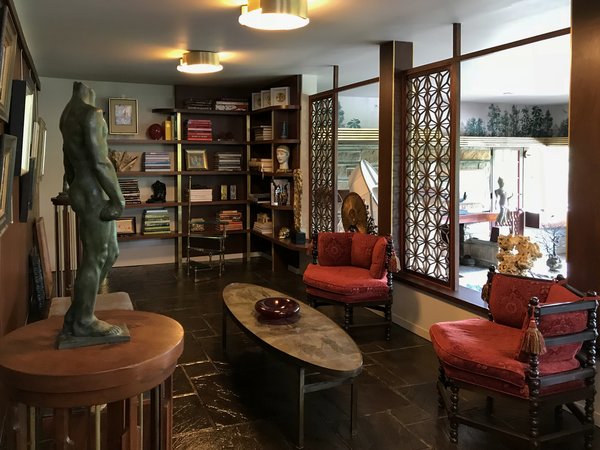 The back corner of the former dance hall is now a library, with new built-in shelving inspired by designs found in the original family apartment. The natural contour of rocks varies along the hillside; Walter embraced this obstacle by designing this space to sit higher than the dance hall.