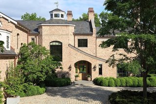 Lush landscaping provides privacy, as does the home's location sited at the end of a circular driveway that can hold up to 20 vehicles. For even more space to park cars, the property also offers a three-car garage and a carport.