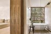 A hallmark of the indoor-outdoor bathrooms is chukum, a smooth stucco popularized by the Mayans. Photo of Jungle Keva Tulum modern home