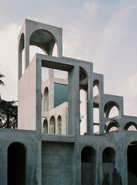 Xavier Corberó built what feels like the world’s biggest kaleidoscope. At the epicenter of the sculptor’s Catalan estate, a six-story structure rises like a contemporary Tower of Pisa. The interior of the tower is a hollow atrium; here, plants dangle and light spangles through arched windows, shining a surreal light show into a cathedral of modernism.