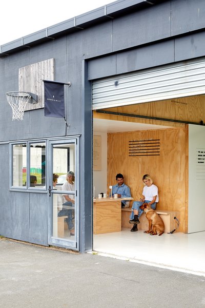 George & Willy announces itself with a flag sign that they no longer produce. The meeting room’s plywood wall has a message display system that makes use of metal rails and Scrabble- like wood tiles.