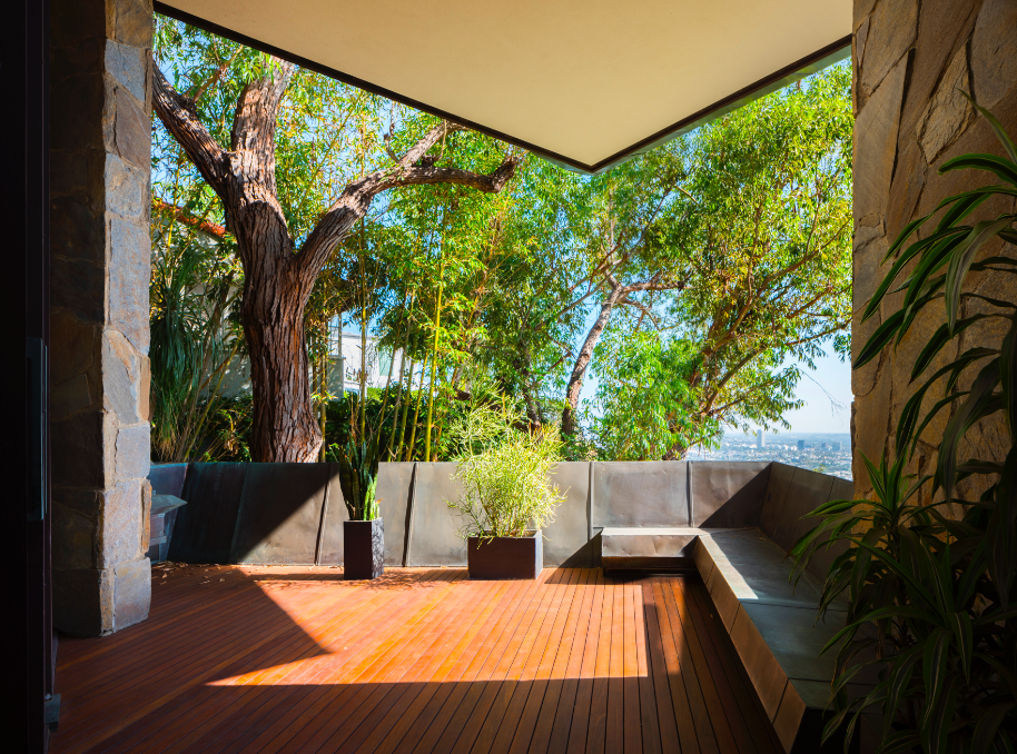 A closer look at the covered terrace just off the living room. The cozy and private space features ample built-in, copper-wrapped seating.