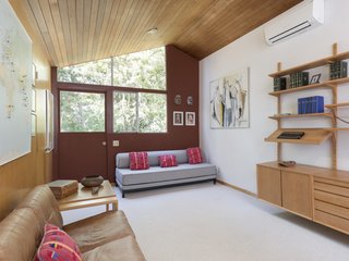 A spacious home office, which can easily be converted depending on the buyer's needs, offers direct access to the outdoors. Large, angled windows invite plenty of light inside.