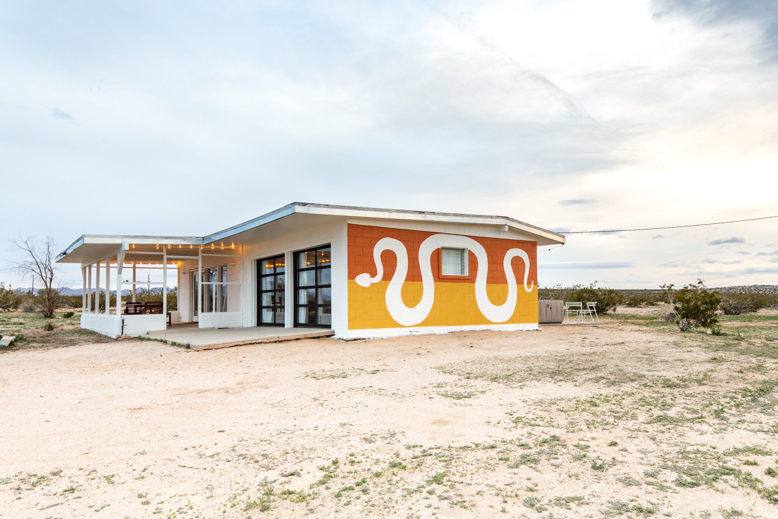 This three-bedroom, three-bath home was given a makeover by artist and designer Lindsay Hollinger. The 1,116-square-foot residence sits on a five-acre lot, and the interior is swathed in natural light. While the space is almost entirely updated, there are remnants of the original house—including an original stone wall that stands as a focal point.
