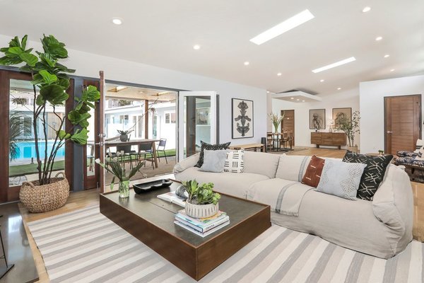 Inside, the U-shaped floor plan spans 3,402 square feet. Vaulted ceilings enhance the sense of space, while skylights and French doors invite in natural light.