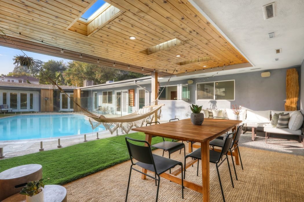 Steps away from the kitchen is a covered outdoor eating area that offers a cabana-like vibe.
