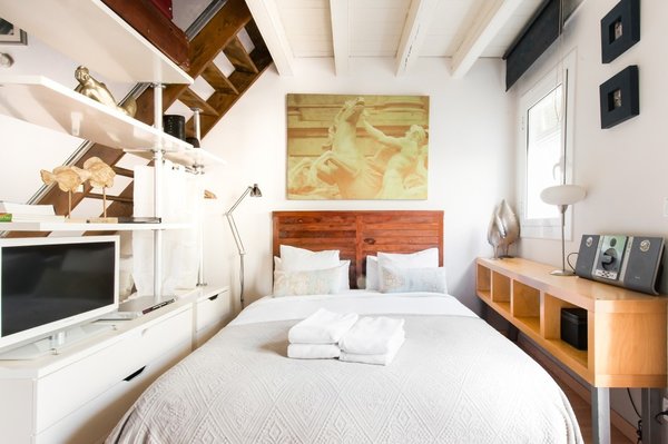 Unwind on the balcony of a 130-year-old building in the heart of the Barcelona's oldest district. Enjoy open-plan, loft-style living with neutral decor, open shelving, rustic exposed-beam ceilings.