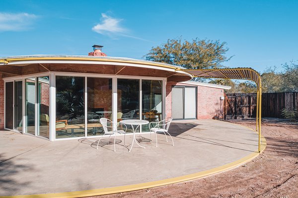 Floor-to-ceiling windows face a revolving patio for wide views of the terrace yard.