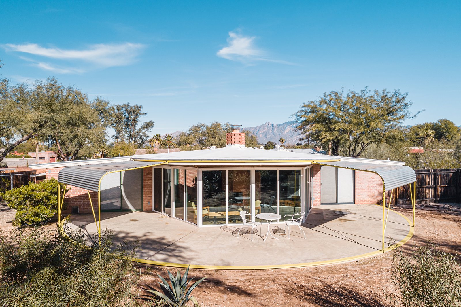 Two awnings on casters can be adjusted to shade or expose the interior to sunlight.