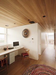 A library and office are built into the second-floor hallway.