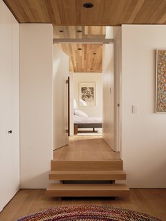 Opposite the desk, steps lead up to the master bedroom.
