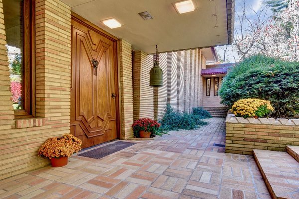Signature elements of Frank Lloyd Wright&rsquo;s style abound&mdash;starting with the front door. 