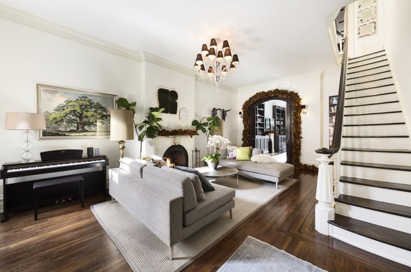 Upon arrival, double entry doors lead into the sun-bathed parlor floor, which is graced by 11' ceilings. Anchored by an original fireplace, the formal living room is dressed in a neutral color palette, complemented by richly textured hardwoods. 