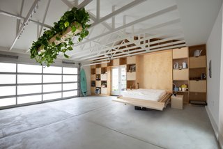 Shelving in the living area holds storage as well as a Murphy bed for guests. "It’s like a Swiss Army knife," says Losada-Amor. "Everything is a tool that you can fold or slice." 