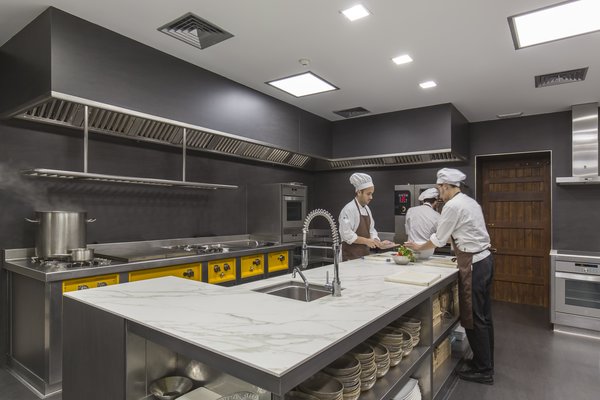The Calacatta countertop (with the chefs in the photo) is 12mm (1/2 inch)