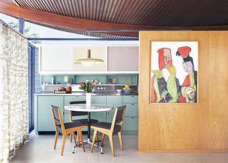 The kitchen was relocated to its designated place and reinstalled as per White’s building specs. A stainless-steel counter and sink, powder-coated cabinets, and sliding panels in pastels replicate the original 1955 version while contemporary updates include Vola faucets, Heath Ceramics tiles, sliding freezer drawers, an induction range, and a refrigerator by Jennair.