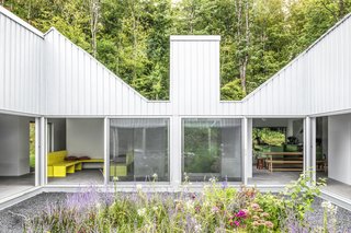 The home spreads out from a courtyard garden in a shape that resembles a hand traced on a sheet of paper. The structure of each “finger” nods to the traditional gable-sided barns that dot the area.