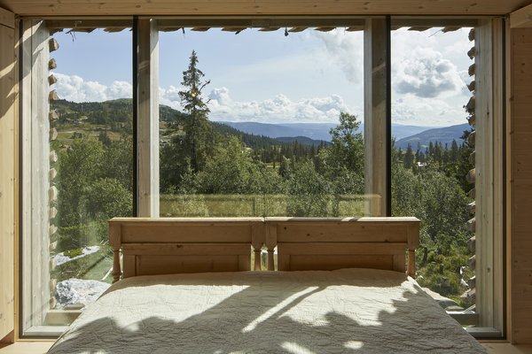 The master bedroom features an antique Norwegian bed rebuilt by Strønes Snekkerversksted.