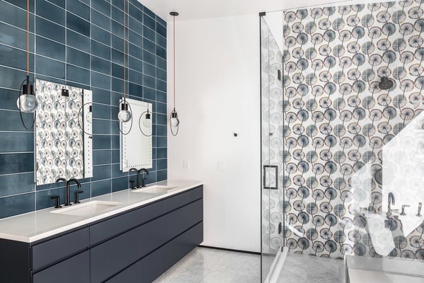 Floral tiles bring pattern and a peaceful color palette to this bathroom.