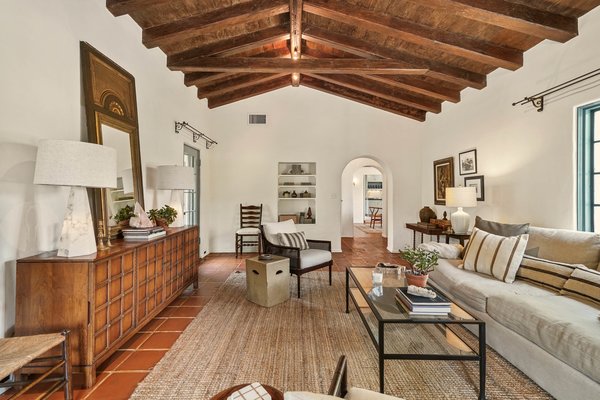 Upon arrival, an entryway leads into the home's main living room where a breathtaking beamed ceiling takes center stage.