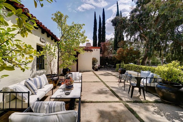 The 1,825-square-foot home is located close to the famous Arroyo Rose Bowl. Past trimmed hedges in the front yard, an expansive outdoor seating area offers a private corner to gather.
