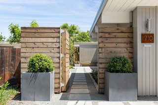 Doors, Exterior, Wood, and Swing Door Type A private courtyard with a stepping-stone path leads to the home's main entrance.