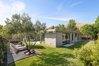 Outdoor, Back Yard, Grass, and Trees A look at the landscaped, fenced-in yard, which wraps around the structure on three sides. The corner lot also features mature fig, persimmon, and lemon trees lining the perimeter.
