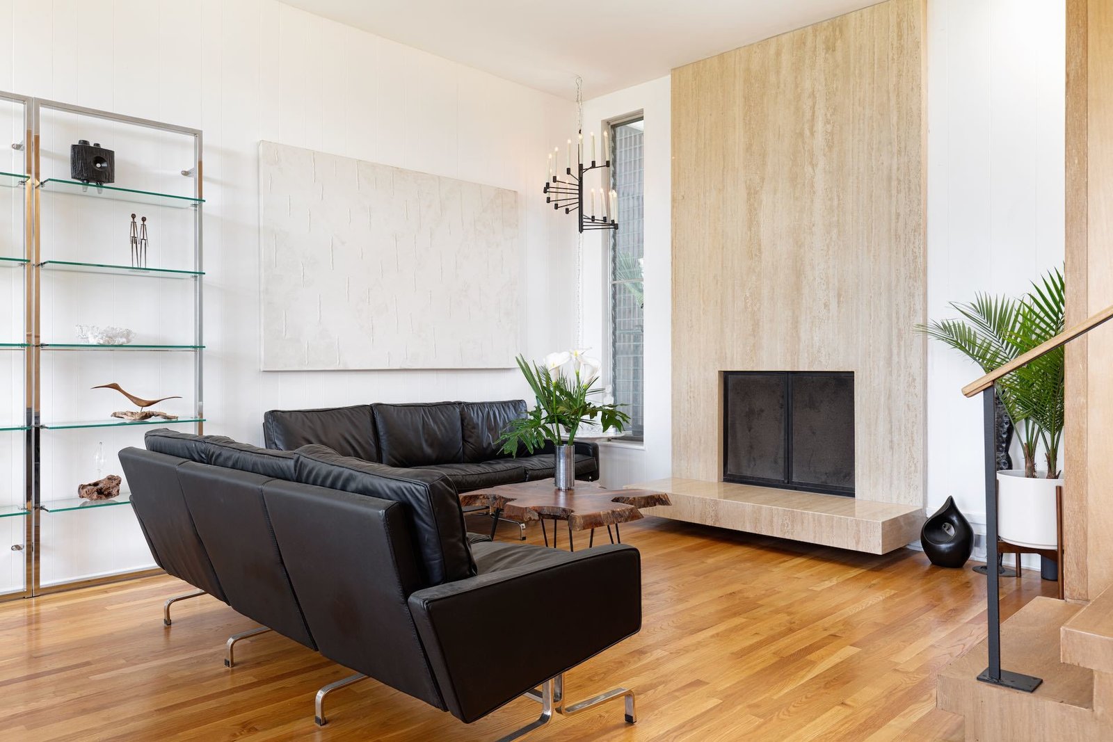 Another view of the living room, showcasing the travertine fireplace.