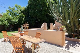 The approximately .20-acre lot also offers a grassy area at the back, as well as an additional outdoor dining area off the kitchen.
