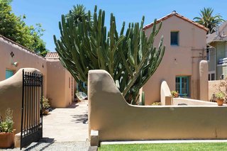 Original adobe walls surround one end of the courtyard.