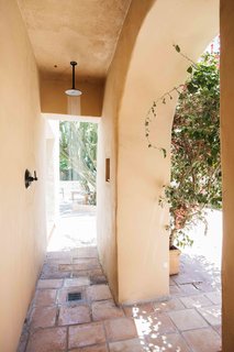 An outdoor shower fills one side of the patio.