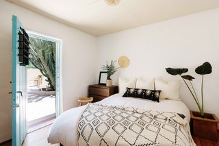The bathroom continues to another bedroom. A door leads directly to the sunny backyard.