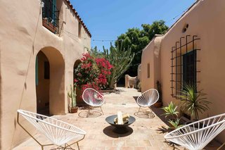 The paved courtyard is nearly 1,000 square feet, complete with archways and an adobe brick wall that encloses the rear of the space.