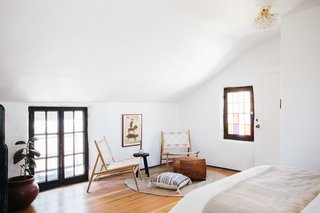Upstairs, a private bedroom with an en suite bathroom fills a second floor above the kitchen.