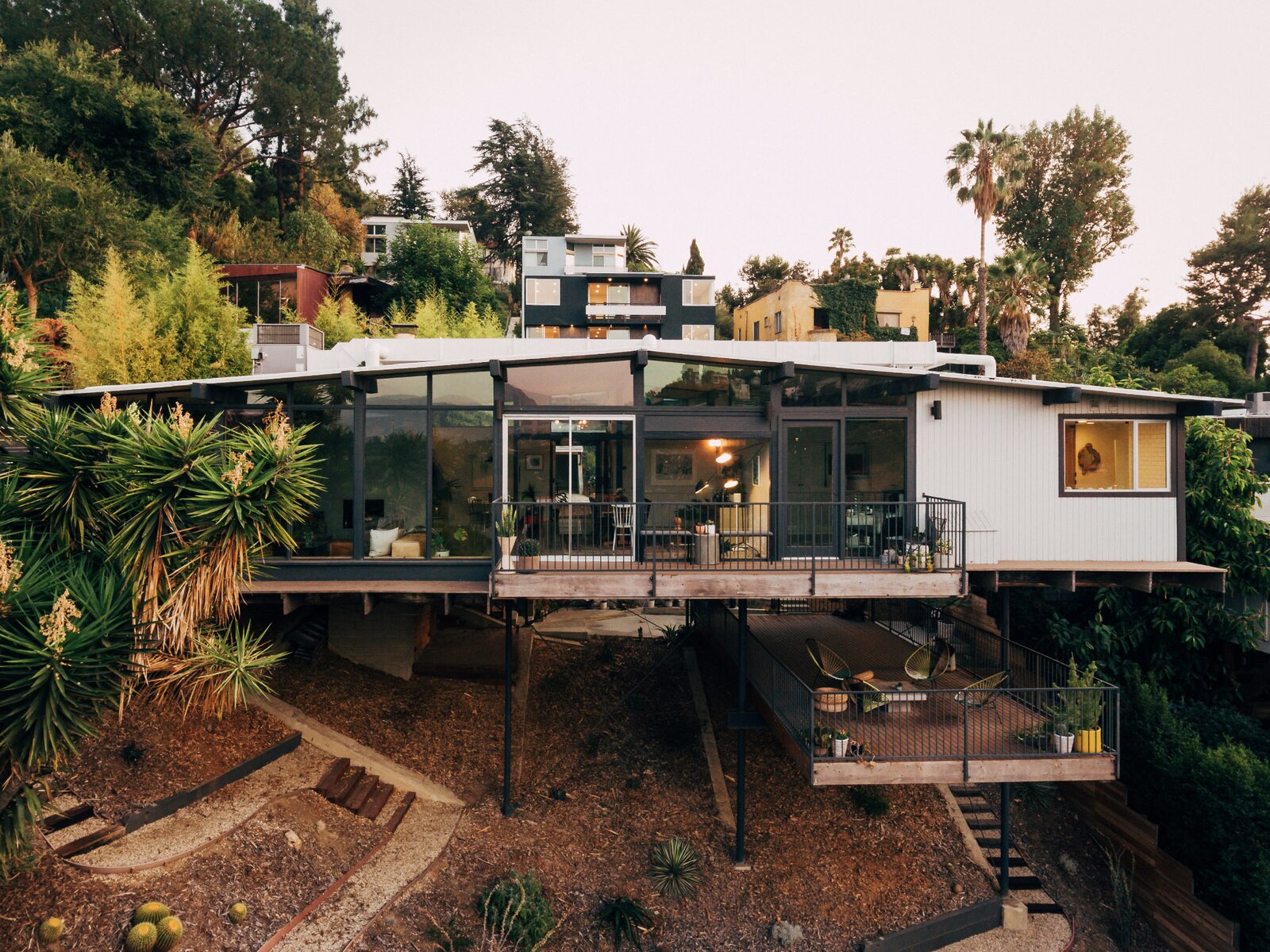 Reportedly one of the first homes built in the neighborhood, this recently listed post-and-beam dwelling is perched along a hillside lot in the Silver Lake area of Los Angeles. The 1962 structure was renovated in 2014 by the team at Tradecraft Real Estate Renovation.