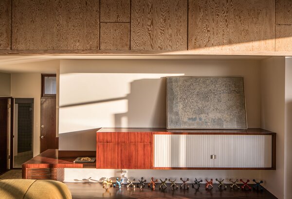 Another view of the penthouse living area provides a closer look at an original built-in cabinet along one wall.