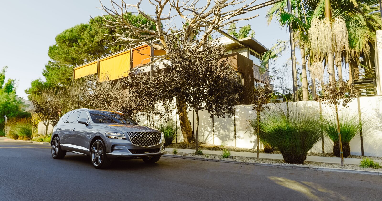 The home’s exterior colors were inspired by the Marrakech souks Steven experienced as a practicing architect in Morocco in the 1970s. A Genesis GV80 is parked outside the residence

Preproduction model with optional features shown.