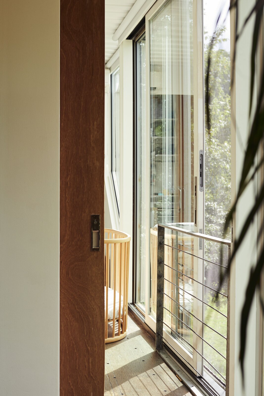 A sliding glass door provides fresh air in one of three bedrooms.