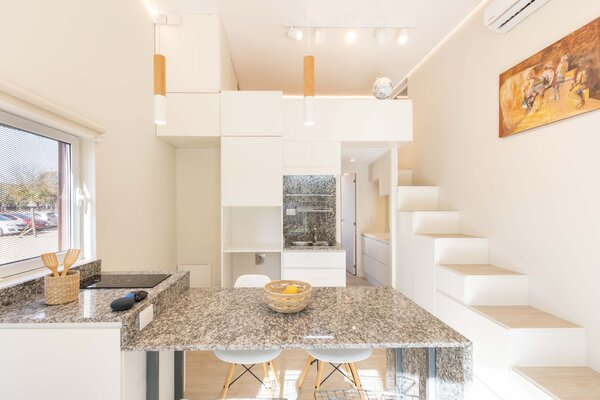 A closer look at the kitchen shows the central countertop that doubles as a dining area.
