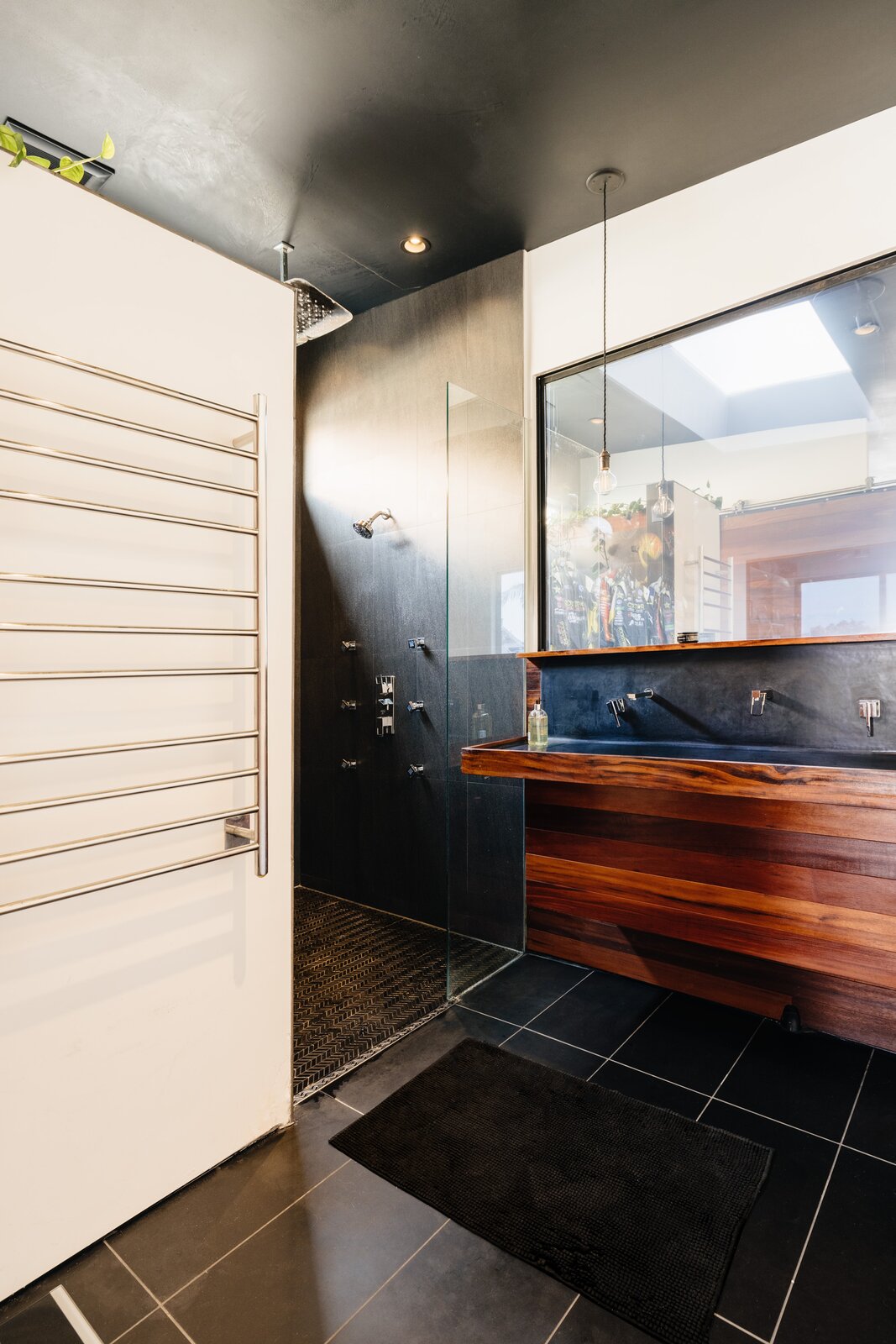 Whereas most vanities have a mirror above the sink, the Foust Residence bathroom has a window that looks into the trophy room.
