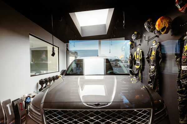 Tanner Foust delights in the surprised expressions on visitors’ faces when they first look into the garage trophy room. The Genesis GV80 can be seen through the glass.

Preproduction model with optional features shown.

