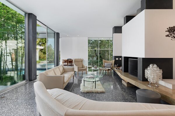 The formal living area features a large wooden hearth and fireplace.