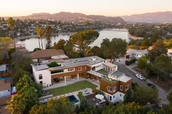 Sited on an expansive 14,219-square-foot lot, the multi-level abode offers ample space and privacy, thanks in large part to the thick vegetation surrounding its perimeter.